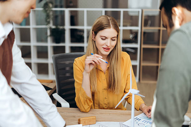istock Engineers discussing about a wind turbine project in the office 2212527181