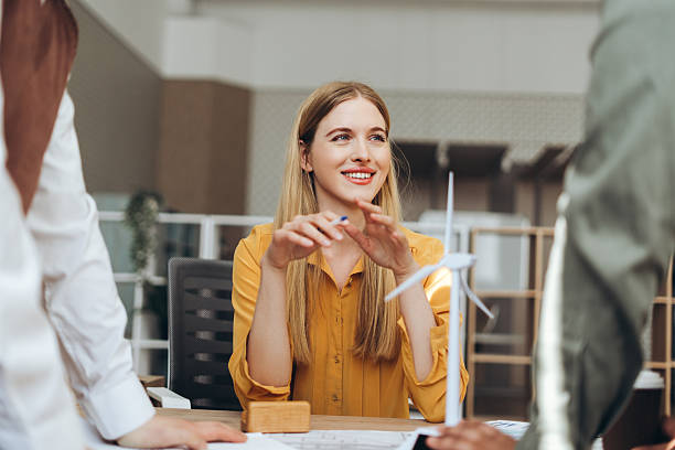 istock Engineers discussing about a wind turbine project in the office 2212527202