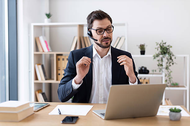 istock Businessman Engaged in Video Call in Office Setting 2212527773