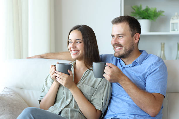istock Happy couple drinking tea and enjoying at home 2212527829