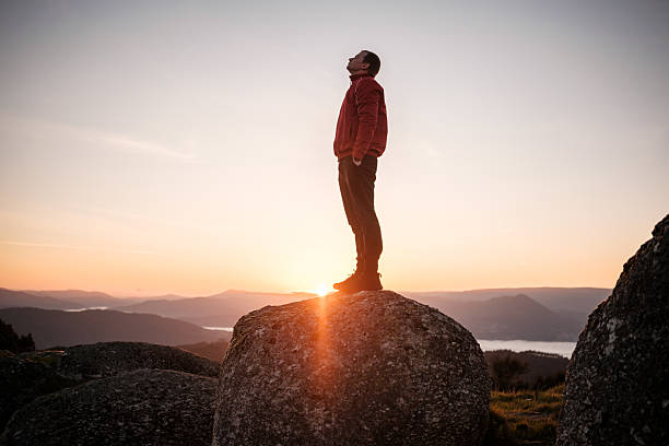 istock Hiker contemplating inspiring sunrise from mountain peak 2212530255
