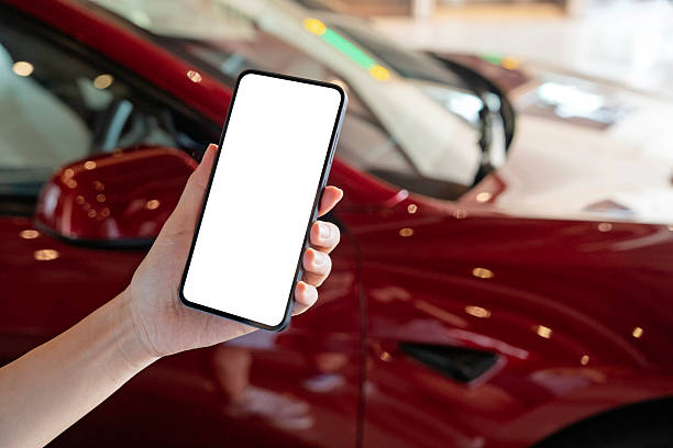 istock Using smartphone to order a ride near luxury car 2212530825