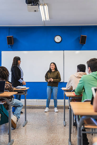 istock High school student giving presentation to classmates 2212531431