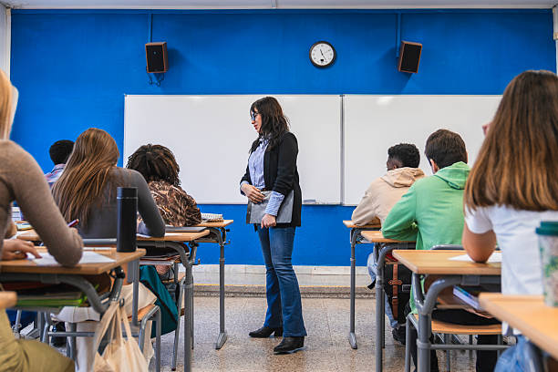 istock High school teacher giving lesson to students in classroom 2212532011