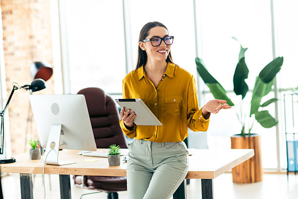istock Modern businesswoman with tablet in stylish workspace featuring natural light and professional decor 2212532055
