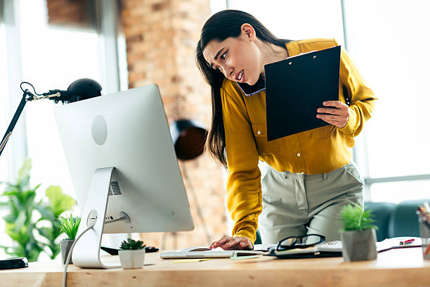 istock Focused businesswoman multitasking in a modern office interior with natural lighting and contemporary workspace design 2212532070