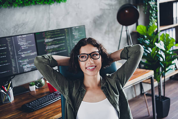 istock Young female programmer enjoying her workspace at home, showcasing a modern and stylish approach to coding and development 2212533756