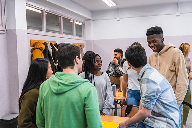 istock High school students chatting together in classroom 2212533877