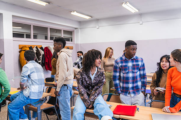 istock High school students chatting and learning in a diverse classroom 2212534131
