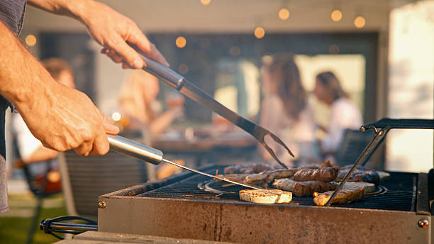 istock Chef Grilling Meat and Vegetables for a Pool Party 2212535291