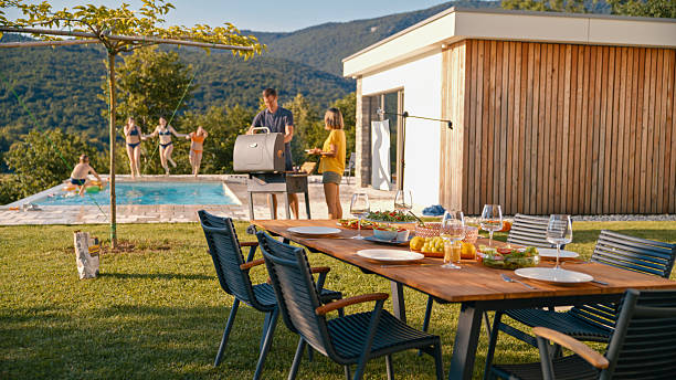 istock Summer Backyard Gathering with Barbecue and Pool Fun 2212535323