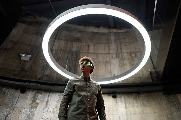 istock Software developer wearing futuristic smart glasses working with virtual reality in modern office 2212535493