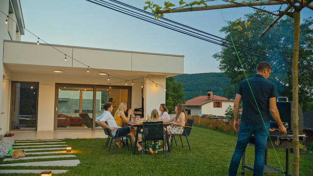 istock Family Enjoying a Barbecue Dinner in Their Backyard 2212535509