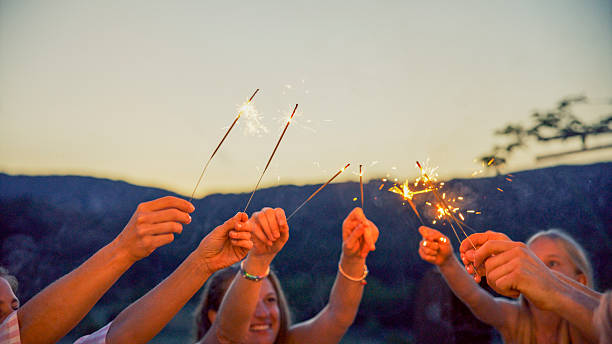 istock Friends Celebrating Outdoors with Sparklers at Dusk 2212535964