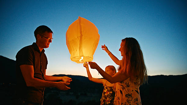 istock Family Releasing a Sky Lantern at Dusk 2212535984