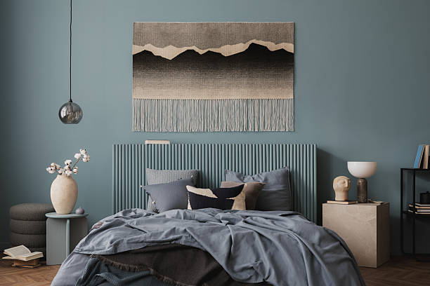istock Elegant bedroom setup with a blue feature wall, textured bedding, and minimalist decor. 2212536832