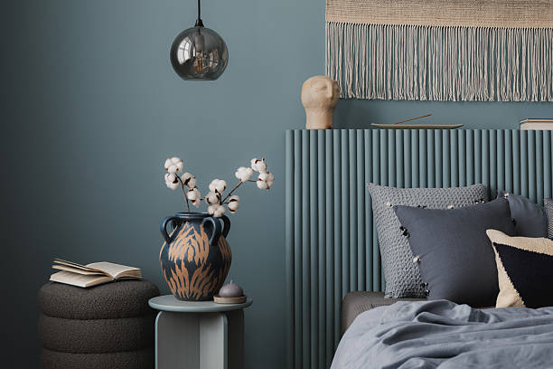 istock Serene bedroom with a sculptural vase on a side table, soft blue bedding, and a woven tapestry adding texture and warmth. 2212536898
