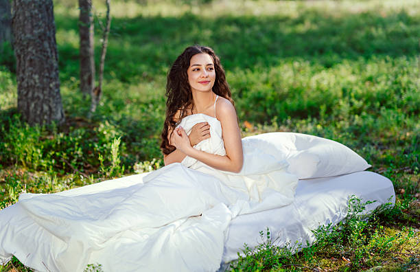istock Girl wakes up in a summer forest 2212538775