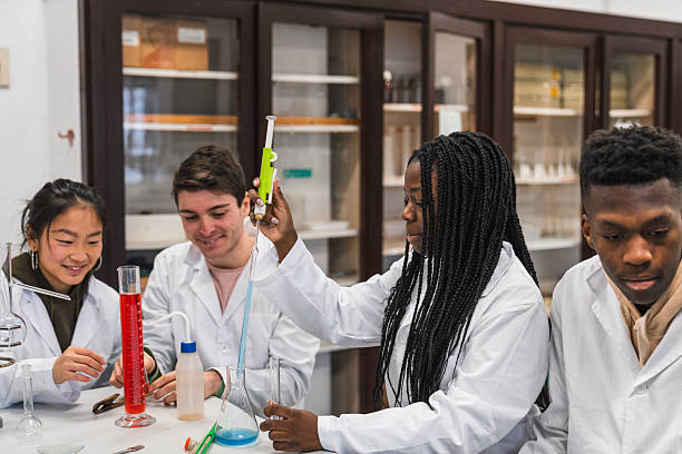 istock High school students conducting chemistry experiment in lab 2212540182