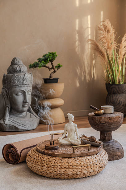 istock Rustic decor featuring a wooden console table with earthy accessories, a Buddha head, and hanging plants. A harmonious mix of natural textures and warm lighting. 2212541014