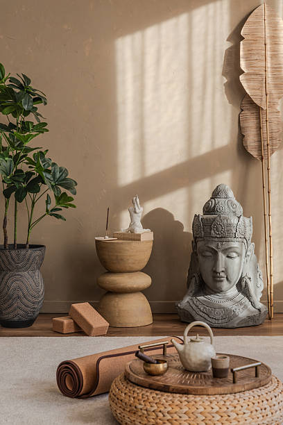 istock Yoga corner with meditation props, including a cork mat, blocks, and a serene Buddha figure. Soft natural light enhances the tranquil setting. 2212541018