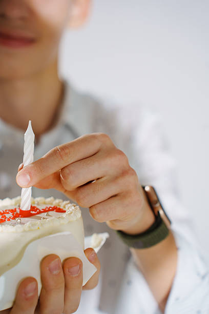 istock Celebrating a birthday with cake and candle in a joyful setting 2212543812