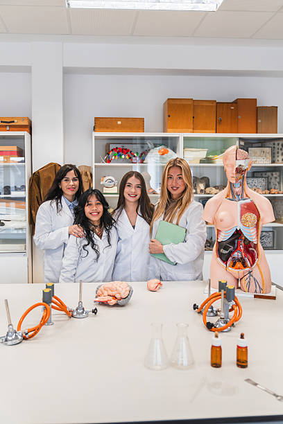 istock High school students smiling in science laboratory classroom 2212544611