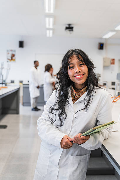 istock Portrait of a smiling high school student in a science lab coat 2212545206
