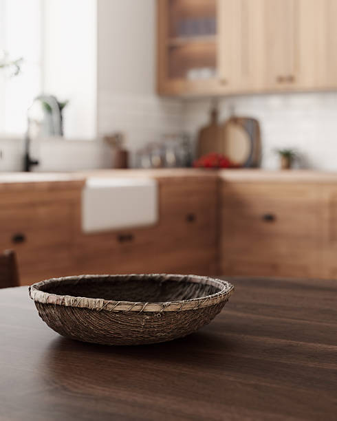 istock 3D render of a cozy rustic kitchen corner. The focus is on a wooden table with a wicker basket. 2212546265