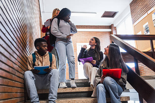 istock High school students chatting on the stairs between lessons 2212546807