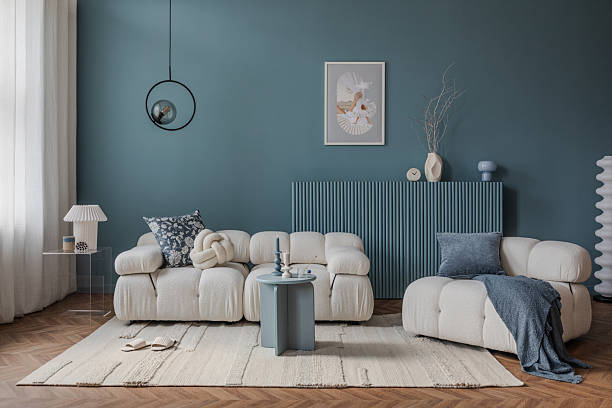 istock A cozy corner featuring a modern-shaped armchair, a decorative cushion, a side table with ceramics, and natural light streaming through the curtains. 2212546995