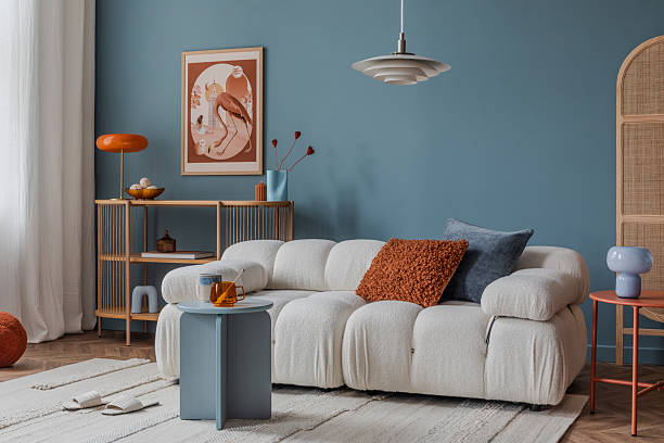 istock Neutral-toned living room corner with layered textiles, a cushioned sofa, and minimalistic decor for a calm ambiance. 2212547016
