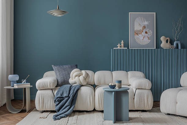 istock Modern design meets comfort with a cream boucle sofa, layered textiles, and a calming blue backdrop. 2212547062