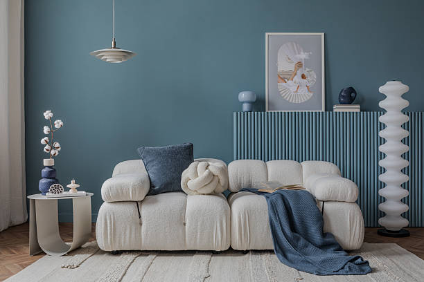 istock Minimalist interior with a boucle sofa, blue accents, and artistic decor, creating a tranquil and stylish atmosphere. 2212547066