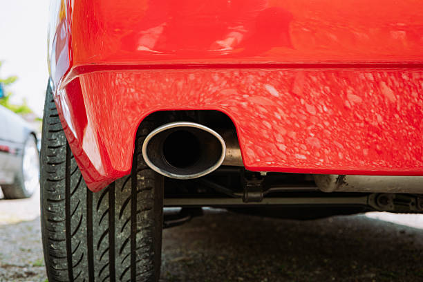 istock Single tip, chromed car exhaust tail pipe close up shot. Low angle, no people 2212547293