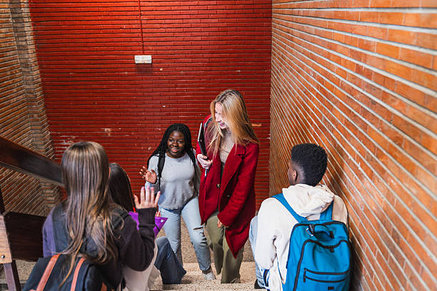 istock High school students walking and talking on stairs 2212547294