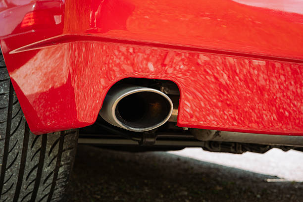istock Single tip, chromed car exhaust tail pipe close up shot. Low angle, no people 2212547304
