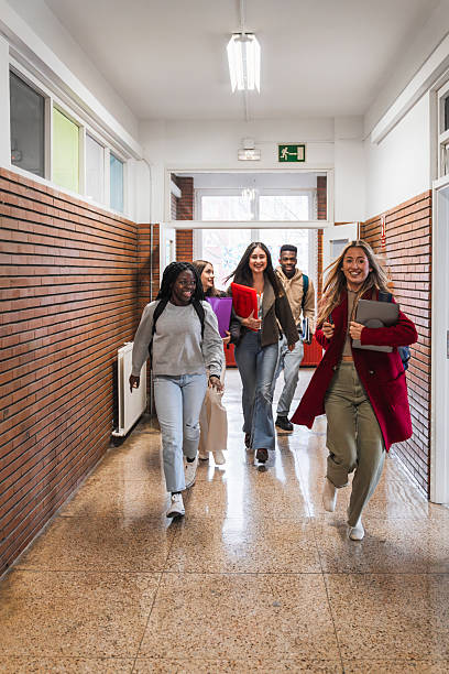 istock High school students running in school hallway 2212548517