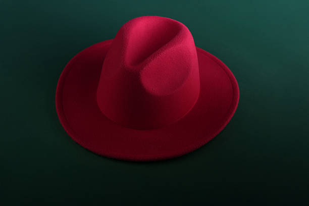 Man in a red jumper and wearing a hat poses as a digital twin, lookig into each other