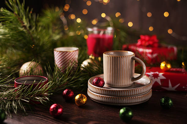 istock Festive Holiday Arrangement with Ceramic Cups Surrounded by Decorative Pine Branches and Vibrant Ornaments, Creating a Cozy and Inviting Atmosphere for Celebrations 2212549232