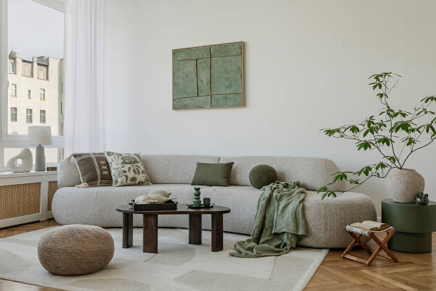 istock A modern, minimalist interior with a large sofa and natural accents. Soft greens bring harmony to the space, creating an elegant, calming atmosphere. 2212549307