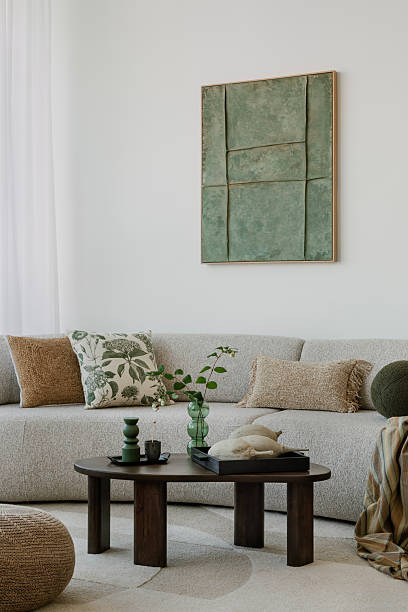 istock A modern, minimalist interior with a large sofa and natural accents. Soft greens bring harmony to the space, creating an elegant, calming atmosphere. 2212549314