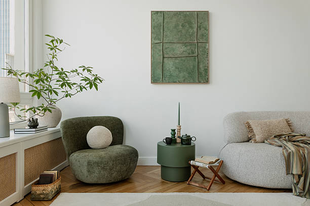 A modern interior with a sofa and elegant natural-colored accents. Large, spacious windows emphasize the openness of the room.