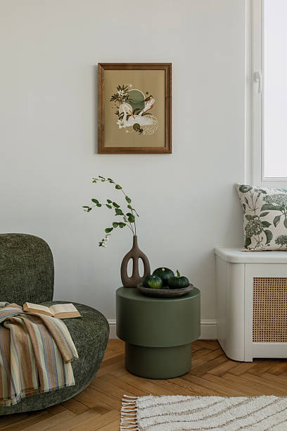 istock Cozy corner with modern sofa, botanical pillows, and soft lighting. Ideal for relaxation and calm moments. Home decor. 2212549533