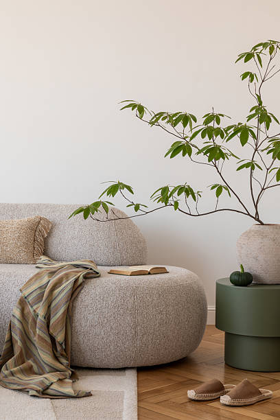 istock Cozy reading nook. A modern living room setup with a plush sofa, soft lighting, and an open bookideal for a quiet reading afternoon. 2212549558