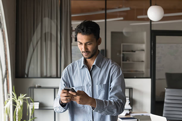 istock Successful Modern Indian Businessman using smartphone 2212550668