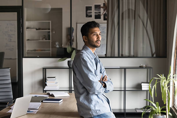 istock Thoughtful confident ambitious Indian businessman looking in window 2212552321