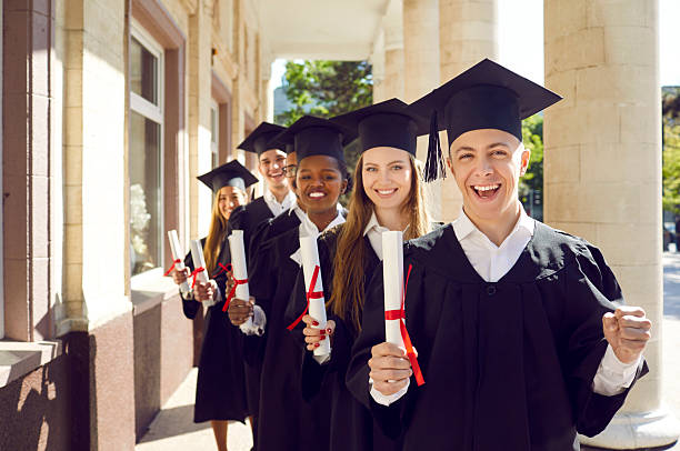 istock College graduates standing behind each other and smiling 2212554764
