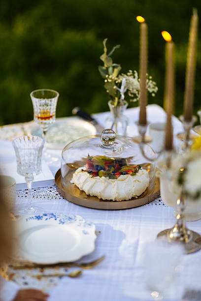 istock A beautifully set table featuring plates, candles, and a cake placed on it 2212554793