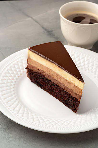 istock Decadent layered chocolate cake served with a cup of coffee on a gray marble table 2212555004